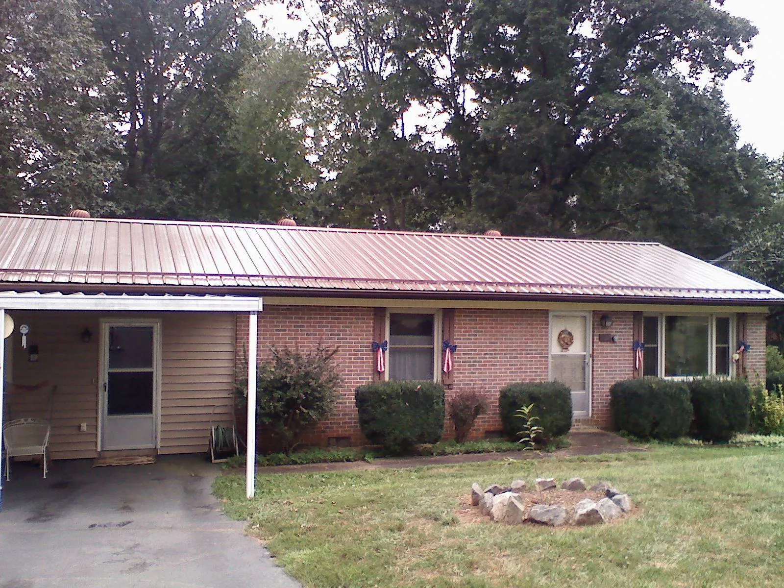Bronze metal roof and carport on a brick ranch home — Roof Repair work by our crew in Cliffwood