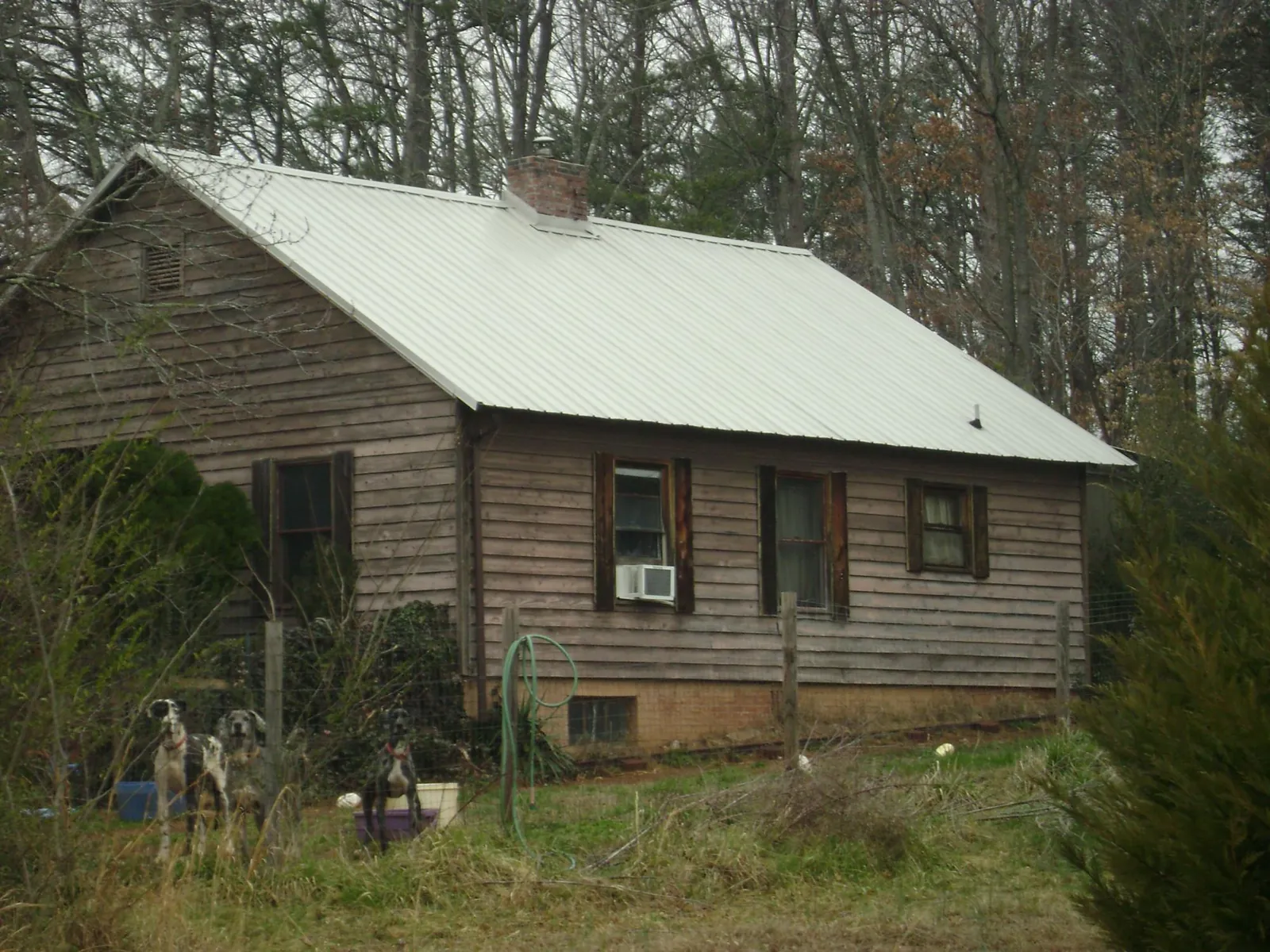 White metal roof on an old wood sided farmhouse, from a Metal Roof Installation job in Cliffwood